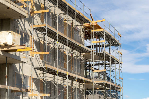 istock Side view photo of wall unfinished house with iron elements on scaffolding 1094143804