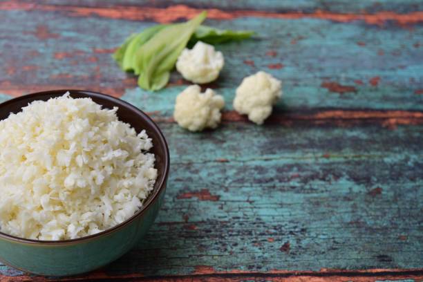 Cauliflower rice in a bowl, negative space