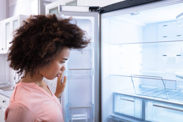 istock African Woman Looking At Empty Refrigerator 1094152944
