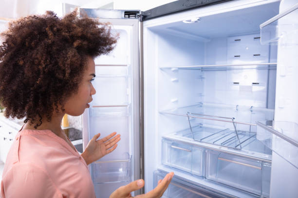 istock African Woman Looking At Empty Refrigerator 1094152956