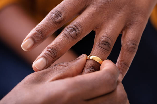 istock Man Putting An Engagement Ring On Woman's Finger 1094158164
