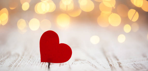 Red paper hearts on light bokeh background. Valentine's day background. stock photo