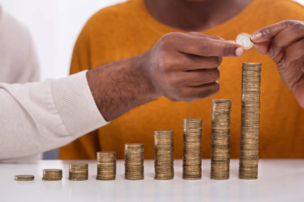 istock Couple Stacking Coins In A Row 1094158856