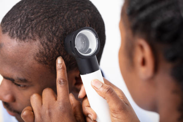 istock Doctor Examining Man's Hair With Dermatoscope 1094161184