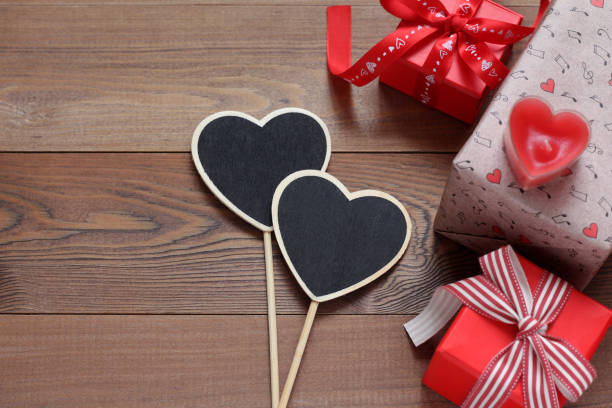 istock Gift boxes with hearts on a wooden table 1094163248