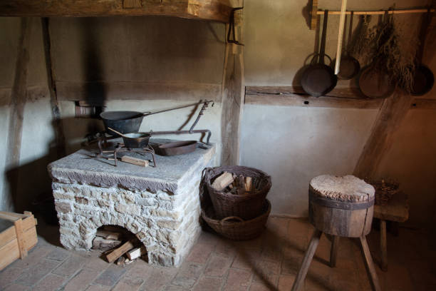 istock Old rural kitchen with fireplace pots and pans 1094163480