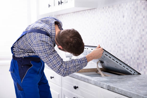 istock Repairman Installing Induction Stove 1094164046