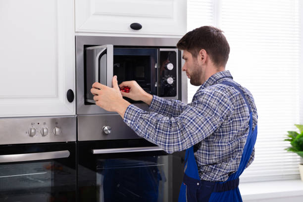 istock Man Repairing Microwave Oven 1094164140