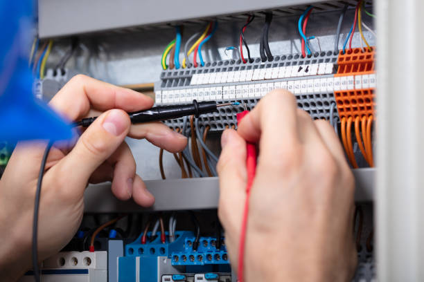 istock Male Electrician Examining Fuse Box With Multimeter 1094164582