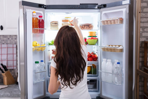 istock Woman Taking Food From Refrigerator 1094166696