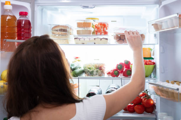 istock Woman Taking Food From Refrigerator 1094167122