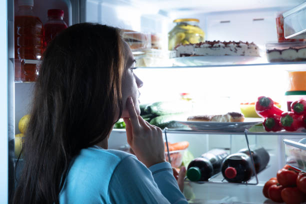 istock Thoughtful Woman Looking For Food In Refrigerator 1094167200