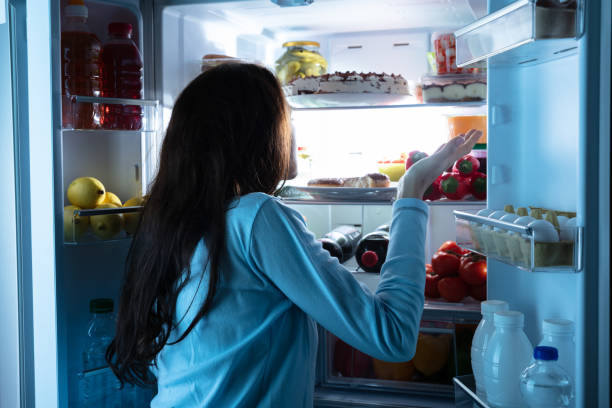 istock Woman Standing In Front Of Refrigerator Shrugging 1094167212