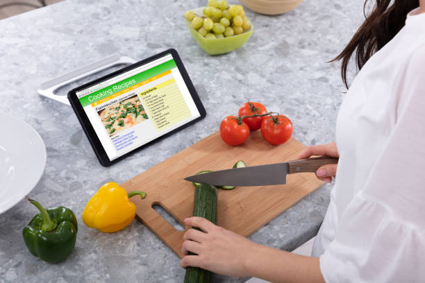istock Woman's Hand Cutting Cucumber With Kitchen Knife 1094168340