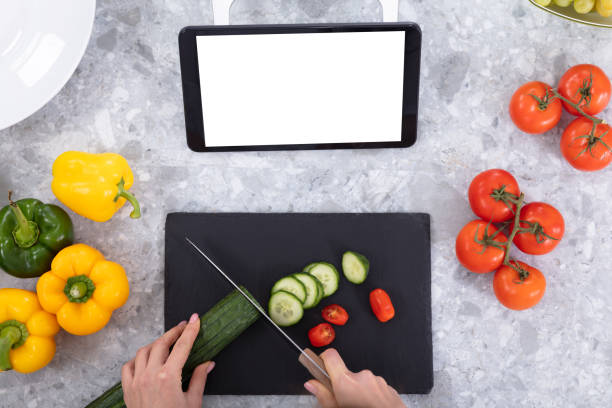 istock Elevated View Of A Woman's Hand Cutting Cucumber With Kitchen Knife 1094168346