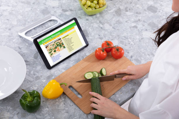 istock Woman's Hand Cutting Cucumber With Kitchen Knife 1094168360