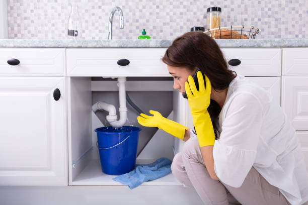 istock Woman Calling Plumber In Front Of Water Leaking From Pipe 1094170724