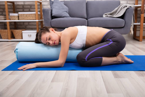 istock Young Woman Practicing Yoga With Bolster 1094180400