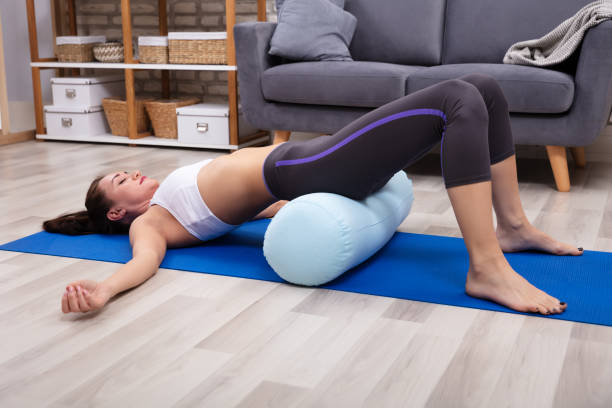 istock Young Woman Practicing Yoga With Bolster 1094180418