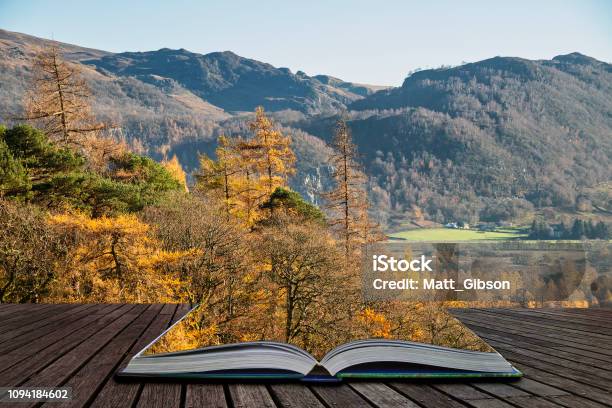 Beautiful Autumn Fall Landscape Image Of The View From Catbells Near Derwentwater In The Lake District With Vivid Fall Colors All Around The Contryside Scene Coming Out Of Pages Of Open Story Book Stock Photo - Download Image Now