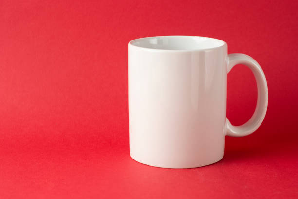 istock White porcelain mug cup isolated on red background with copy space. Coffee or tea cup. 1094187470