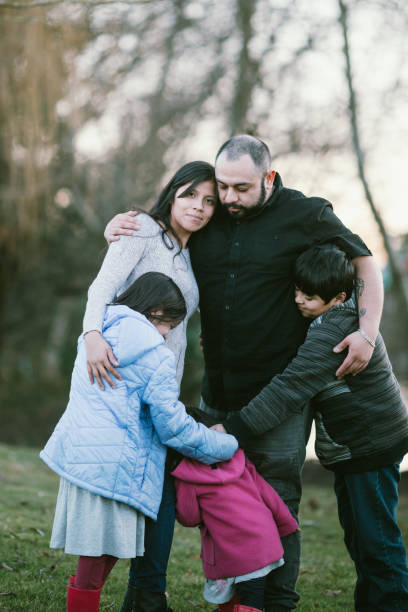 istock Young Hispanic Family Has a Group Hug At Park 1094190238