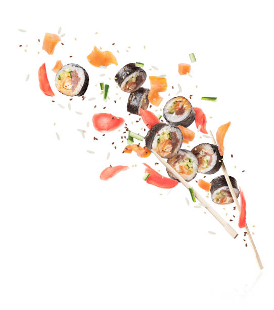 istock Fresh sushi rolls with chopsticks frozen in the air, image in high resolution on a white background 1094190556