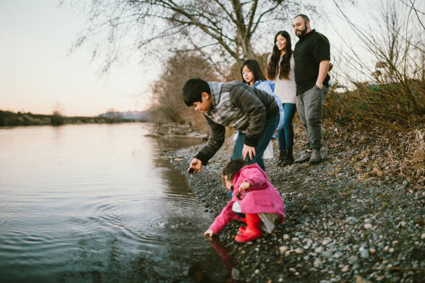 Loving Hispanic Family Together At River Waterfront