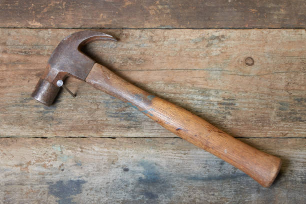 istock Old hammer and nail on distressed wooden boards 1094197958