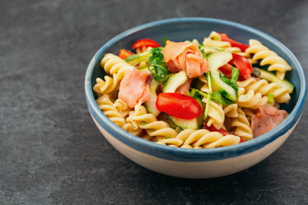 Salad with smoked salmon and pasta Salad with smoked salmon and pasta vinegar stock pictures, royalty-free photos & images