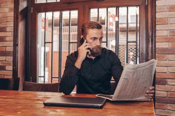 istock Bearded businessman  reading a newspaper 1094202420
