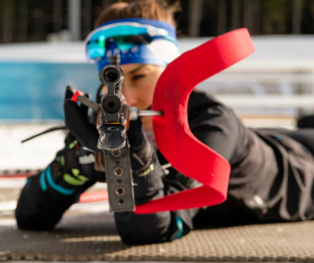 istock Front View of Young Female Biathlon Competitor Practicing Target Shooting, Shallow DOF 1094202576