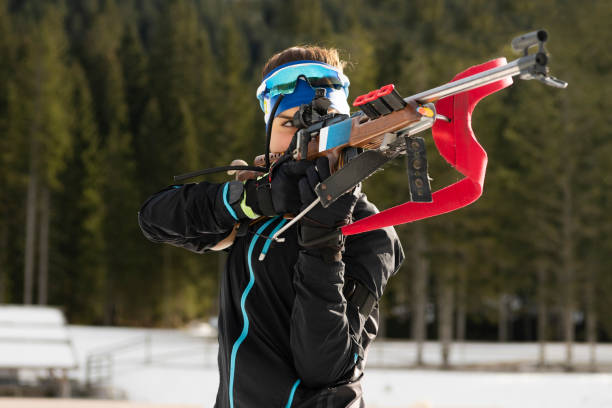 istock Front View of Young Female Biathlon Competitor Practicing Target Shooting, Standing Position 1094202808