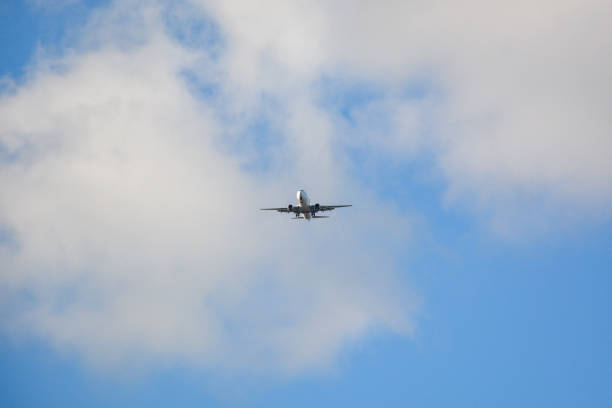 istock Passenger airplane landing against blue cloudy sky 1094203226
