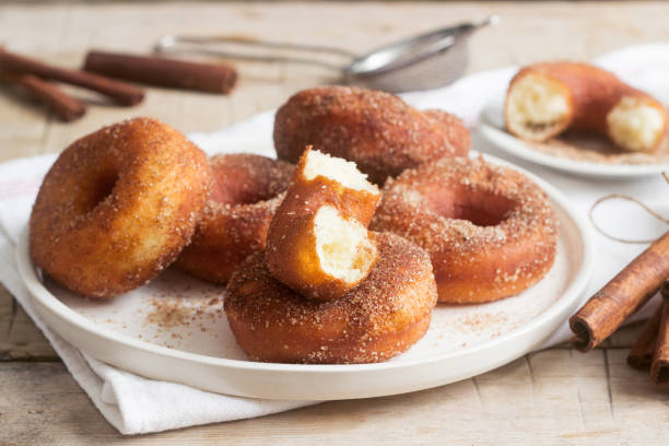 istock Homemade donuts with sugar and cinnamon on a wooden background. Rustic style. 1094204522
