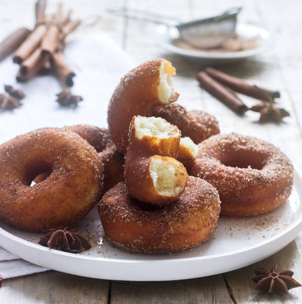 istock Homemade donuts with sugar and cinnamon on a wooden background. Rustic style. 1094204526