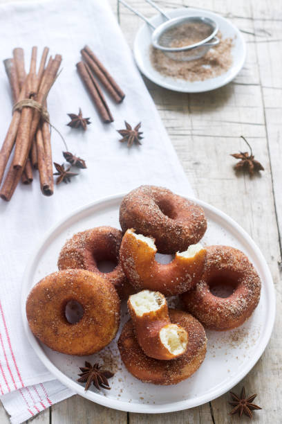 istock Homemade donuts with sugar and cinnamon on a wooden background. Rustic style. 1094204530