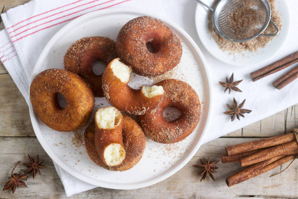 istock Homemade donuts with sugar and cinnamon on a wooden background. Rustic style. 1094204532