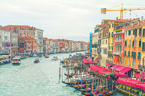 View from Rialto Bridge on heavy traffic of boats, hotels and Restaurants on Grand Canal.