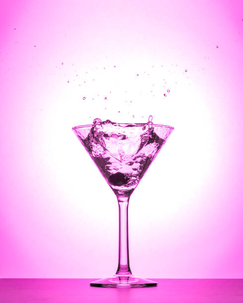 istock Cocktail martini glass splash on white and pink gradient background isolated 1094212770