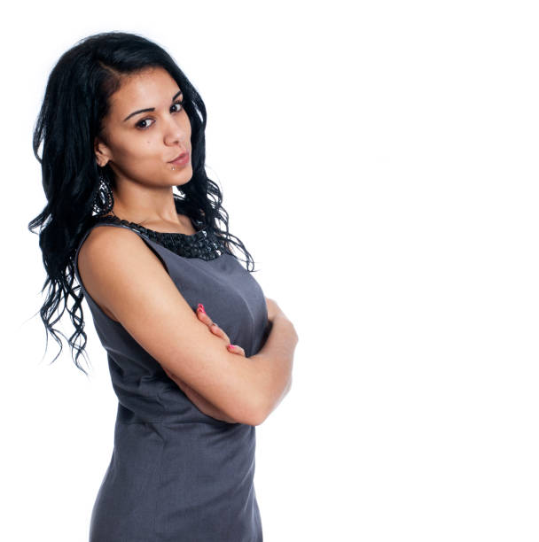 Young business woman standing with arms folded stock photo