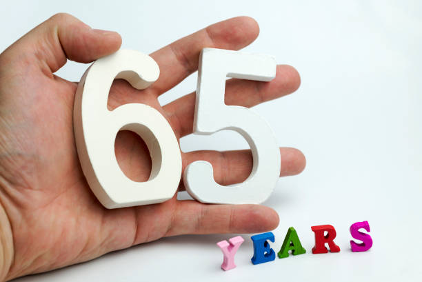 istock Hand holds a figure of sixty-five. 1094218954
