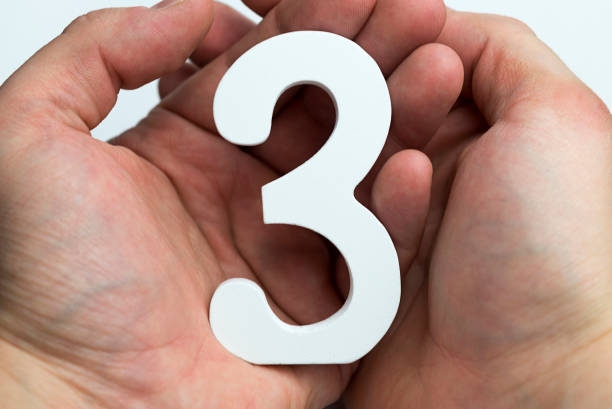 istock Hands on a white background holding number 3 1094219146