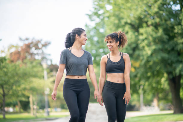 istock Women walking through a park together 1094219850