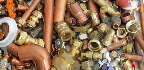 Random mixture of copper pipe and brass fittings ideal for use as a website header  background
