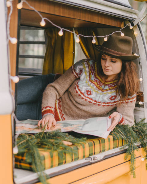 istock Woman reading map in vintage  camper van 1094221826