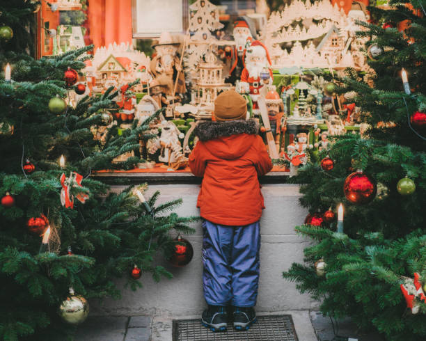 Little boy  standing near Christmas tree in Rothenburg Little  Caucasian boy standing near Christmas tree in Rothenburg in winter window shopping stock pictures, royalty-free photos & images