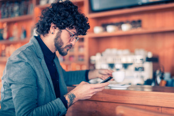 istock Man sitting in the coffee shop and using phone 1094226542