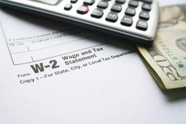 W-2 Tax Form With Calculator & Twenty Dollar Bill stock photo