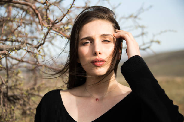 young beautiful woman walks through park